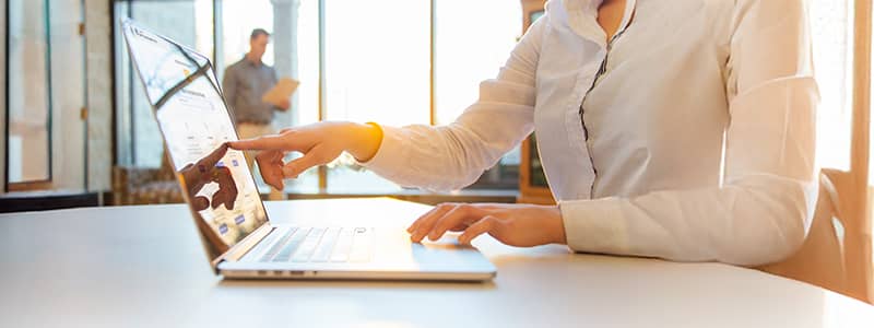 Safety professional reviewing Emergency Response safety plan template from J. J. Keller SAFFETY MANAGEMENT SUITE, the plans & policies section of the site shows on a laptop screen.