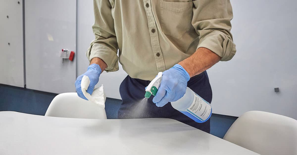 disinfecting and cleaning surfaces in office