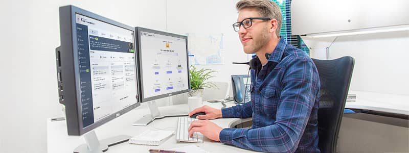 Safety professional reviewing Emergency Response safety plan template from J. J. Keller SAFFETY MANAGEMENT SUITE, the plans & policies section of the site shows on a laptop screen.