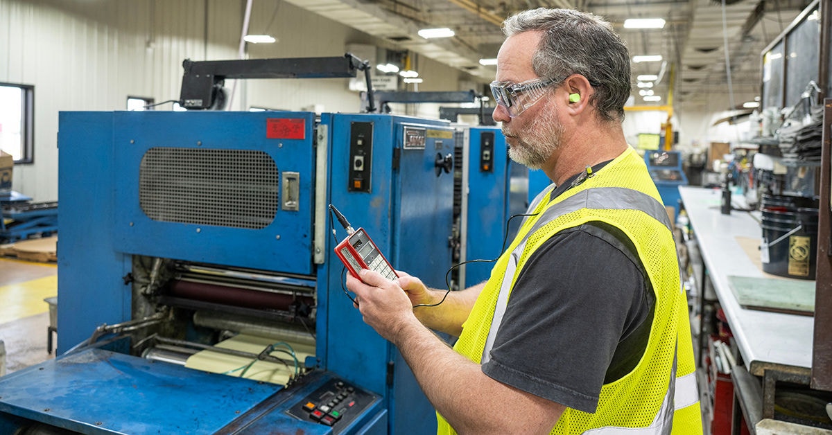 Man monitoring the noise in a manufacturing setting
