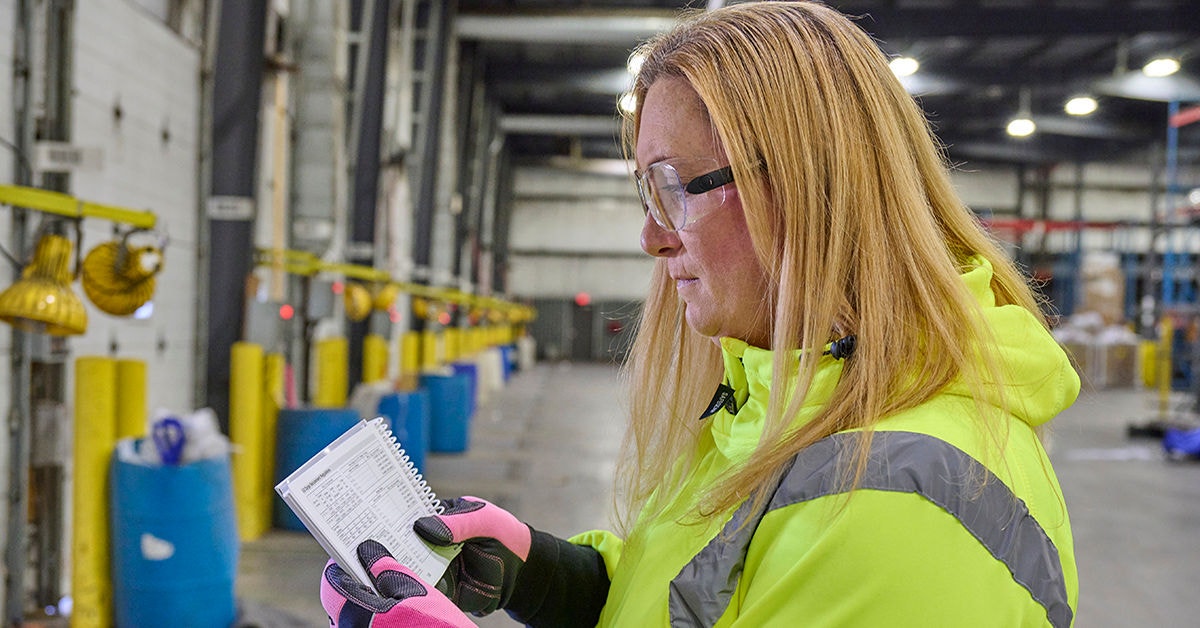 woman looking at safety handbook