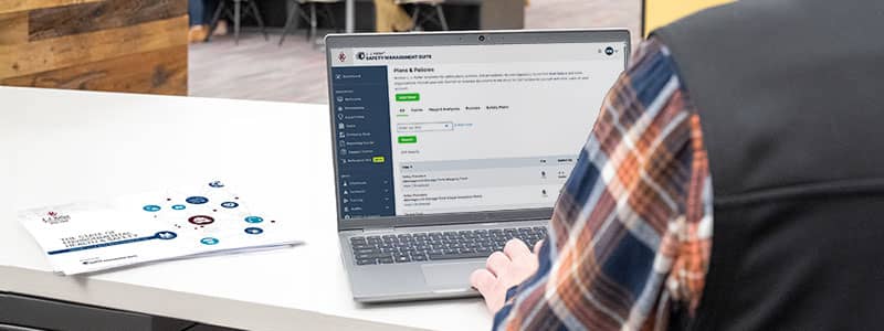 Safety professional reviewing Plans and Policies on screen