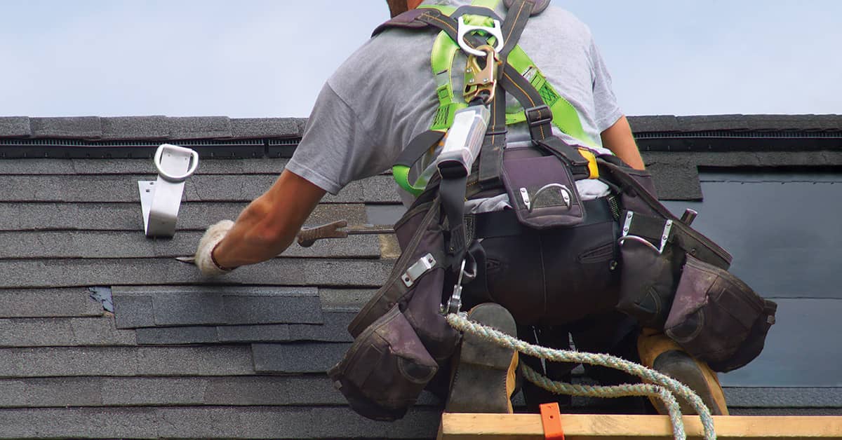 Construction worker on roof with fall protection