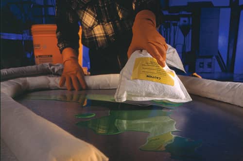 Chemical spill being cleaned up with a spill kit